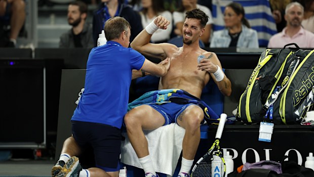 Thanasi Kokkinakis of Australia receives treatment on his shoulder.