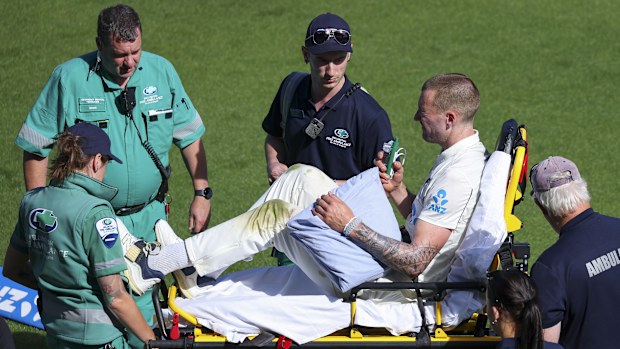 Blair Tickner of New Zealand stretchered off the field