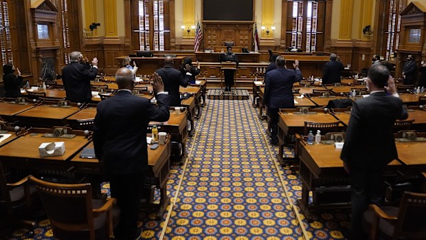 Members of Georgia's Electoral College are sworn in before casting their votes at the state Capitol, Dec. 14, 2020