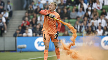 MELBOURNE, AUSTRALIA - DECEMBER 17: Tom Glover of Melbourne City picks up a flare to remove it from the pitch during the round eight A-League Men's match between Melbourne City and Melbourne Victory at AAMI Park, on December 17, 2022, in Melbourne, Australia. (Photo by Darrian Traynor/Getty Images)