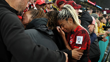 MELBOURNE, AUSTRALIA - JULY 31: Ashley Lawrence of Canada is consoled by her family after the team's 0-4 defeat and elimination from the tournament following the FIFA Women's World Cup Australia & New Zealand 2023 Group B match between Canada and Australia at Melbourne Rectangular Stadium on July 31, 2023 in Melbourne / Naarm, Australia. (Photo by Alex Grimm - FIFA/FIFA via Getty Images)