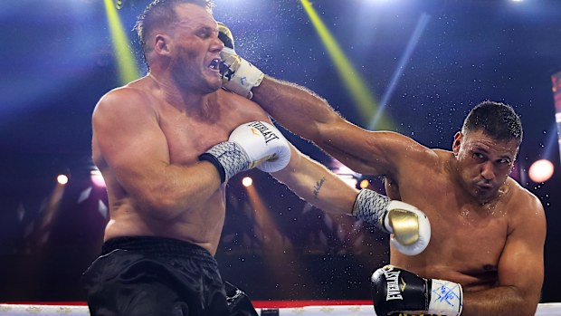 Justin Hodges (R) lands a punch on Nathan Ross.