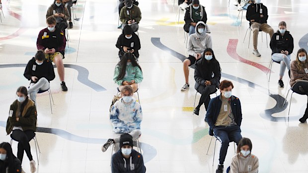 Students wait to receive the Pfizer vaccine for Covid-19 at Judos Arena, Sydney.