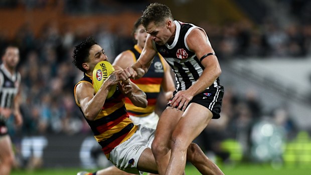 Izak Rankine is knocked down after being bumped by Dan Houston.