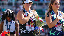 EUGENE, OREGON - JUNE 26: Gwendolyn Berry (L), third place, turns away from U.S. flag during the U.S. National Anthem as DeAnna Price (C), first place, and Brooke Andersen, second place, also stand on the podium after the Women's Hammer Throw final on day nine of the 2020 U.S. Olympic Track & Field Team Trials at Hayward Field on June 26, 2021 in Eugene, Oregon. In 2019, the USOPC reprimanded Berry after her demonstration on the podium at the Lima Pan-American Games. (Photo by Patrick Smith/Gett