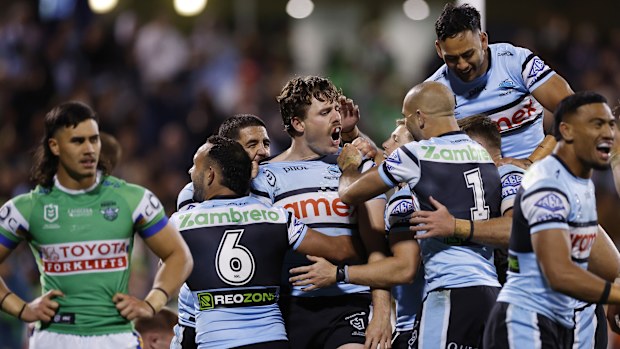 Sharks players celebrate a try.