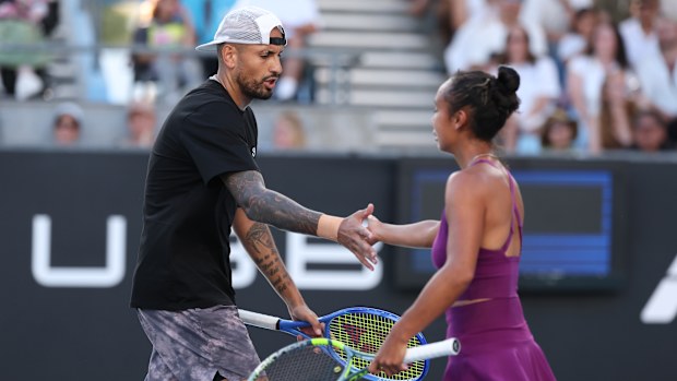 Nick Kyrgios high fives Leylah Fernandez while competing in the mixed doubles.