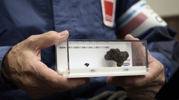 Akira Ono, chief decommissioning officer at the Tokyo Electric Power Company Holdings(TEPCO), holds model of nuclear fuel debris which was extracted from the damaged Fukushima Daiichi nuclear power plant last year, during an interview with the Associated Press Wednesday, March 5, 2025, in Tokyo.