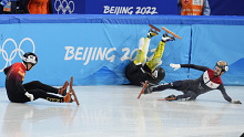 Ren Ziwei, left, of China, Brendan Corey of Australia, and Itzhak Laat, right, of the Netherlands, crash in their quarterfinal of the men's 1,000-meter during the short track speedskating competition at the 2022 Winter Olympics, Monday, Feb. 7, 2022, in Beijing. (AP Photo/Natacha Pisarenko)