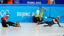 Ren Ziwei, left, of China, Brendan Corey of Australia, and Itzhak Laat, right, of the Netherlands, crash in their quarterfinal of the men's 1,000-meter during the short track speedskating competition at the 2022 Winter Olympics, Monday, Feb. 7, 2022, in Beijing. (AP Photo/Natacha Pisarenko)