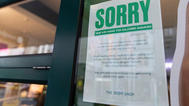 A sign hangs outside a shop apologising for closing its doors as lockdown due to the continuing spread of the coronavirus starts in Melbourne, Wednesday, Aug. 5, 2020. 