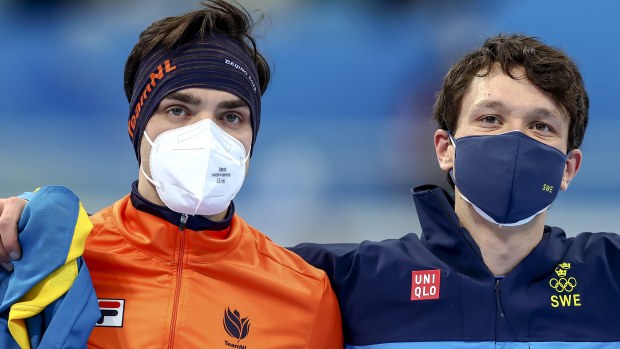 Dutchman Patrick Roest and Sweden's Nils van der Poel at the 5000m track ceremony.