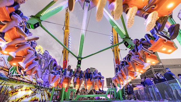 People ride The Beast, which reaches speeds of 120km/h and swings 38 metres high while doing a 360 degree spin, at the The Sydney Royal Easter Show on 05 April, 2021. Photo: Brook Mitchell