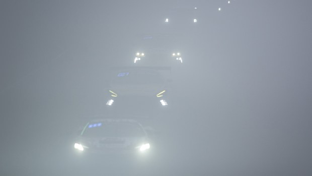 Racing cars drive through the fog in the Döttinger Höhe section of the 24-hour race on the Nürburgring's Nordschleife. Photo: Silas Stein/dpa (Photo by Silas Stein/picture alliance via Getty Images)