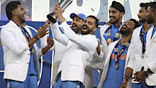 India's Virat Kohli and teammates celebrate with the trophy of the ICC Champions Trophy.