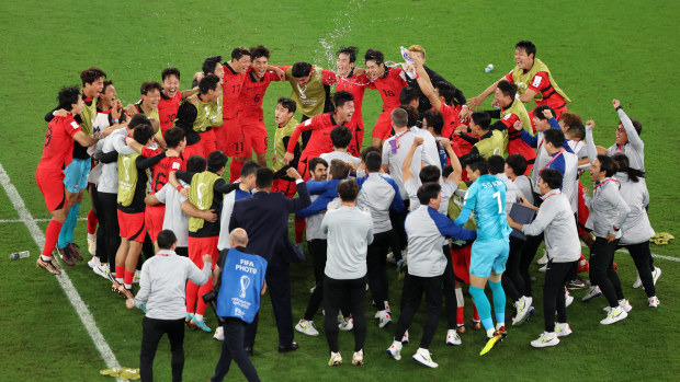 Korea Republic players celebrate after the team's qualification to the knockout stages during the FIFA World Cup Qatar 2022 Group H match between Korea Republic and Portugal at Education City Stadium on December 02, 2022 in Al Rayyan, Qatar. (Photo by Mohamed Farag/Getty Images)