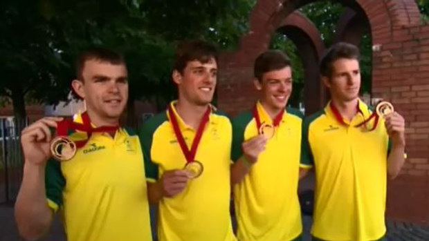 Athletes pose with their medals. 