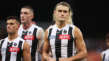 Darcy Moore of the Magpies and team mates look dejected after their loss to Sydney in Opening round.