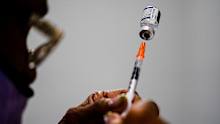 FILE - A syringe is prepared with the Pfizer COVID-19 vaccine at a vaccination clinic at the Keystone First Wellness Center in Chester, Pa., Dec. 15, 2021. The White House is planning for what it calls dire contingencies that could include rationing supplies of vaccines and treatments this fall if Congress doesnt approve more money for fighting COVID-19. Biden administration officials have been warning for weeks that the country has spent nearly all the money approved for COVID-19 response. (AP 