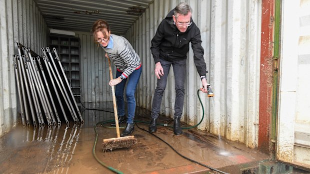 NSW Premier Dominic Perrottet and Emergency Services Minister Stephanie Cooke help with the clean-up at Enzo Cucina, Camden in Sydney's south west.