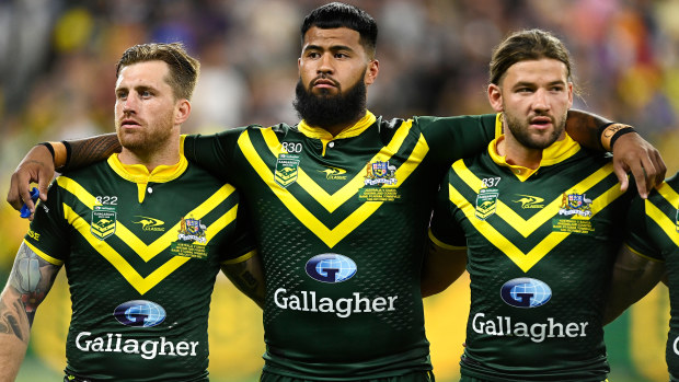 Kangaroos players Cameron Munster, Payne Haas, and Patrick Carrigan during the national anthem.