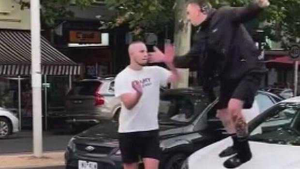 Footage has emerged of two men trading blows in the middle of a busy Melbourne bringing traffic to a standstill.The three men can be seen brawling in the middle of a busy intersection in Carlton, close to the CBD. 