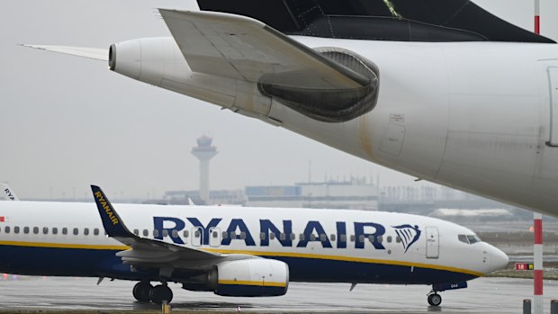 A Ryanair Boeing 737-8AS taxis past another aircraft on the apron at Frankfurt Airport in Frankfurt, Berlin, Friday, Jan. 7, 2022. Budget airline Ryanair says it will stop serving Germanys busiest airport at the end of March and close its base there. Ryanair said Friday, Jan. 7, 2022 that it's reallocating five planes it has based at Frankfurt Airport to other European airports that have responded with lower airport charges to stimulate traffic recovery. (Arne Dedert/dpa via AP)