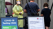 Health care workers dressed in Personal Protection Equipment (PPE) are seen at the Royal Prince Alfred (RPA) Hospital COVID-19 clinic in Sydney, Sunday, January 9, 2022. NSW has recorded its deadliest day since the COVID-19 pandemic began, with 30,062 new cases and 16 deaths during the past 24hr reporting period. Photo: Bianca De Marchi/The Sydney Morning Herald