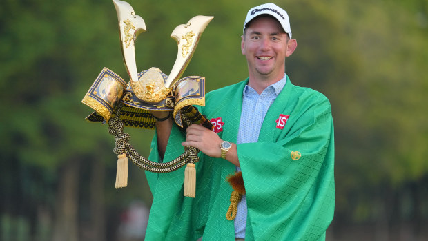 Lucas Herbert of Australia poses with the trophy for winning the ISPS Handa Championship.