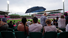 A general view as bad light and rain stops play with fans sheltering under an umbrella on day one of the fifth NRMA Insurance Ashes Series 2025 test at the Sydney Cricket Ground, Australia. Picture date: Sunday January 4, 2026. (Photo by Robbie Stephenson/PA Images via Getty Images)