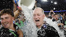 Michael Maguire cops the customary Gatorade shower.