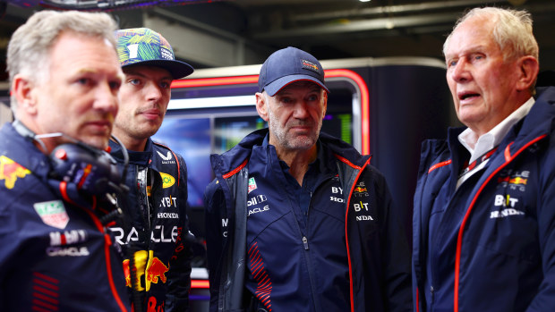 Red Bull Racing team principal Christian Horner, driver Max Verstappen, chief technical officer Adrian Newey and team consultant Helmut Marko look on in the garage.
