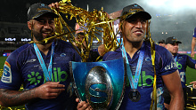 Akira Ioane (left) and Rieko Ioane (right) of the Blues celebrate with the trophy during the Super Rugby Pacific final match at Eden Park.