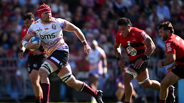 Harry Wilson of the Reds charges towards the try line to score.