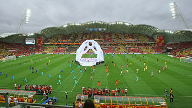 Performers surrounded a stage resembling a giant football.