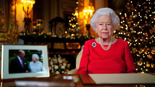 Queen Elizabeth II records her annual Christmas broadcast in the White Drawing Room at Windsor Castle on December 23, 2021 in Windsor, England. The photograph on the desk is of The Queen and the Duke of Edinburgh, taken in 2007 at Broadlands, Hampshire, to mark their Diamond Wedding Anniversary. 