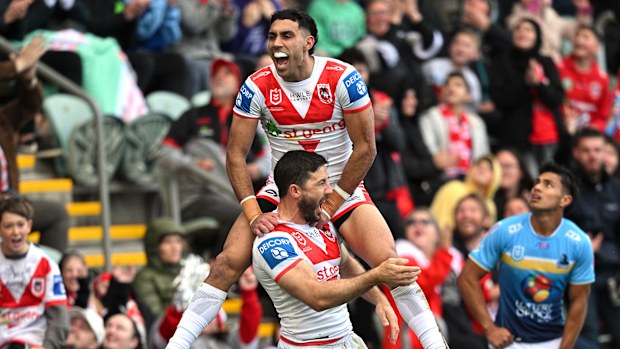 Tyrell Sloan celebrates scoring a try with Ben Hunt.