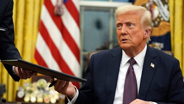 President Donald Trump signs executive orders in the Oval Office of the White House, Jan. 20, 2025, in Washington.