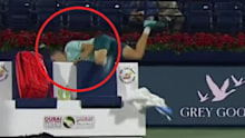 Hubert Hurkacz falls over his seat at the Dubai Tennis Championships. 
