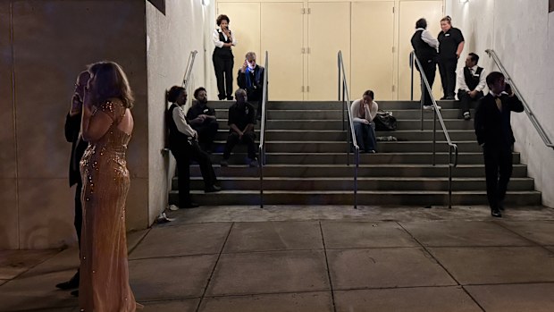 Attendees and hotel workers outside of the venue following the security incident.