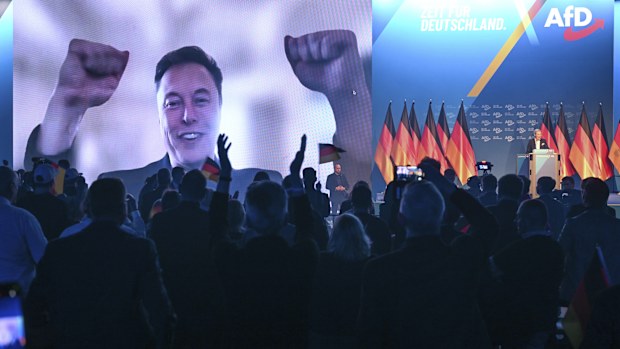 U.S. businessman Elon Musk is shown during a live video link, as Alice Weidel,  AfD candidate for chancellor takes to the stage, during the AfD's election campaign kick-off, in Halle, Germany, Saturday, Jan. 25, 2025. (Sebastian Willnow/dpa via AP)