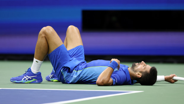 Novak Djokovic of Serbia falls down after a point against Daniil Medvedev of Russia during their Men's Singles Final match on Day Fourteen of the 2023 US Open at the USTA Billie Jean King National Tennis Center on September 10, 2023 in the Flushing neighborhood of the Queens borough of New York City. (Photo by Matthew Stockman/Getty Images)