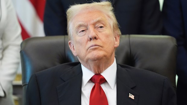 President Donald Trump listens as Health and Human Services Secretary Robert F. Kennedy Jr. speaks during an event about drug prices.