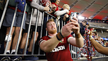 Ollie Chessum of the British and Irish Lions takes a selfie with fans in Perth.
