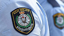 A former child abuse inquiry team leader has been awarded $1.8 million after a judge found NSW Police missed several opportunities to prevent psychological trauma.