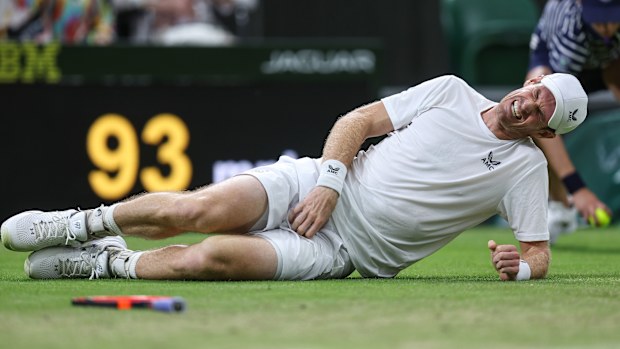 Andy Murray (GBR) grabs his groin as he falls to the ground in pain during his match against Stefanos Tsitsipas (GRE) during day four of The Championships Wimbledon 2023 at All England Lawn Tennis and Croquet Club on July 6, 2023 in London, England.