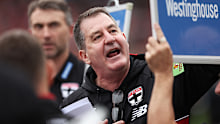 Saints head coach Ross Lyon speaks to players.