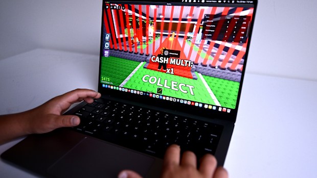 A child is seen playing a game on the Roblox platform. The platform will not be included in Australia's social media ban.