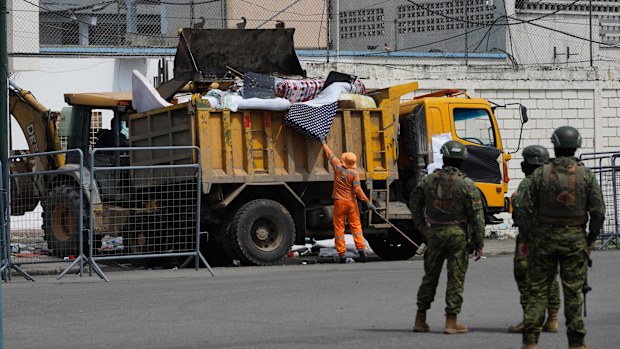 Soldiers stand guard outside the prison where inmates were killed during clashes between themselves in Machala, Ecuador