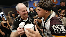 SYDNEY, AUSTRALIA - OCTOBER 05: Michael Maguire head coach and Reece Walsh of the Broncos celebrate victory in the change rooms following the NRL Grand Final match between the Melbourne Storm at Brisbane Broncos at Accor Stadium on October 05, 2025 in Sydney, Australia. (Photo by Darrian Traynor/Getty Images)